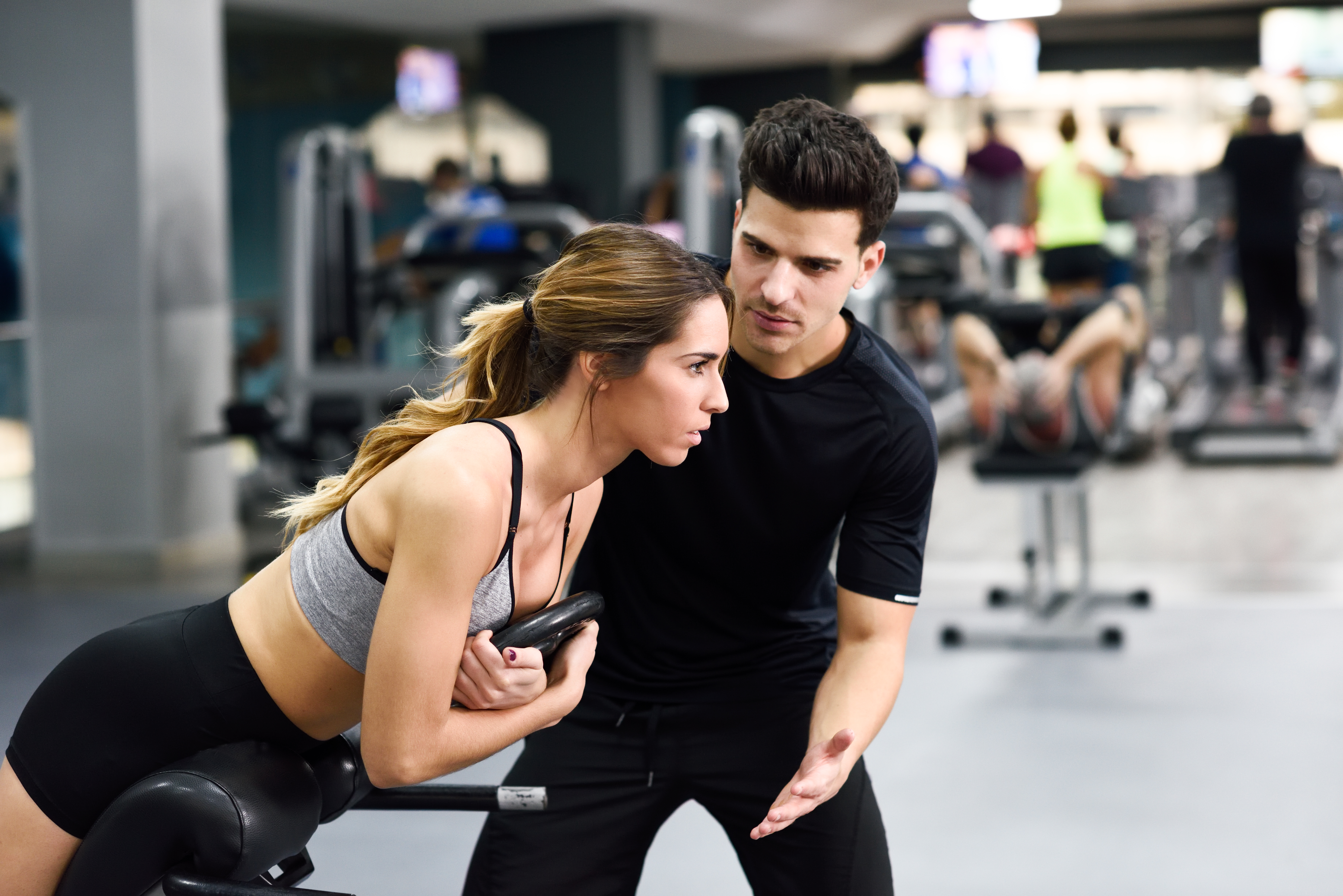 Personal trainer coaching a client at Iron Colosseum